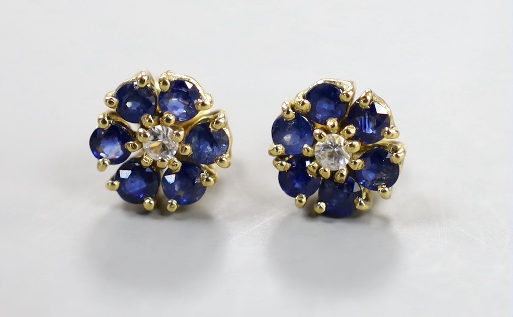 A pair of yellow metal, sapphire and diamond set flower head cluster earrings, 9mm, gross weight 3.7 grams.